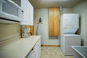 A compact kitchen with a microwave, coffee maker, and a built-in washer and dryer. - Fair Haven - Great App Ski Mtn Location! (Blowing Rock)