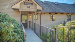 A building with a sign reading 'Willow 116' and a covered entrance. - One Level Entry 3 bed 3 bath condo at Chetola (Blowing Rock)