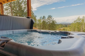 A hot tub with a view of trees and mountains in the background. - NEW! A-Frame, Hot Tub, MTN Views, Game & Movie Room (Divide)