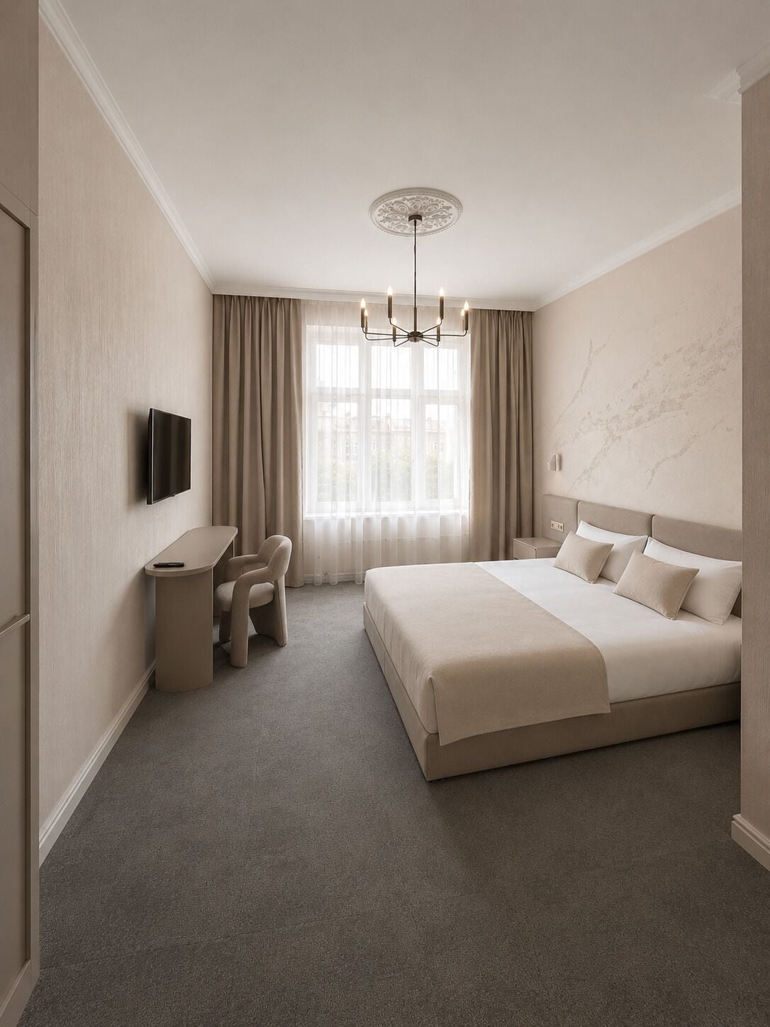 A hotel room with a bed, a desk, a chair, a TV, and a window with curtains.