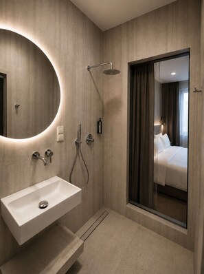 A modern bathroom with a built-in sink, shower, and a large mirror. - Kleparski House (Kraków)