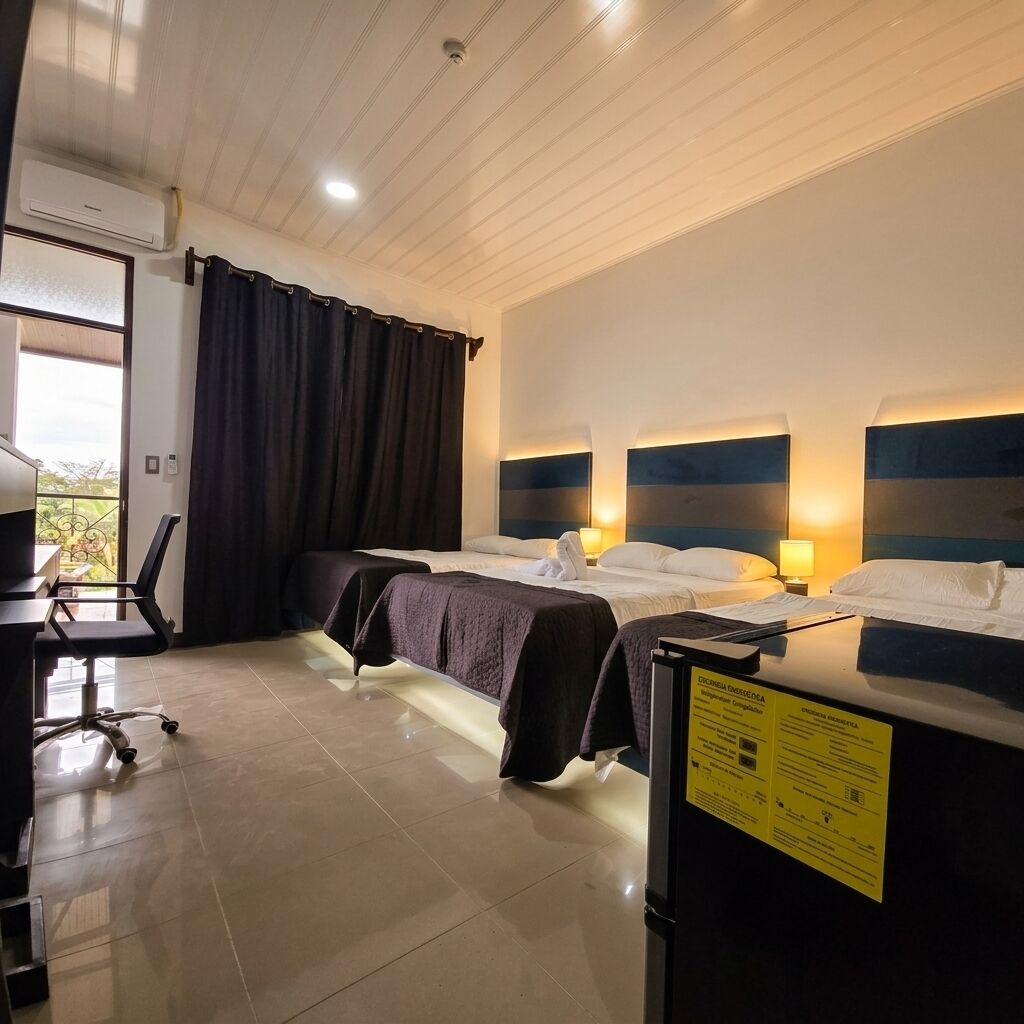 A hotel room with two beds, a desk, and a chair.
