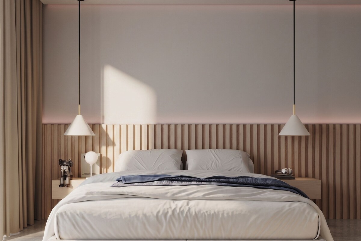 Ein modernes Schlafzimmer mit einem großen Bett, zwei Pendelleuchten, einem Holzschabrnenkopf und einem Nachttisch mit einer Lampe.