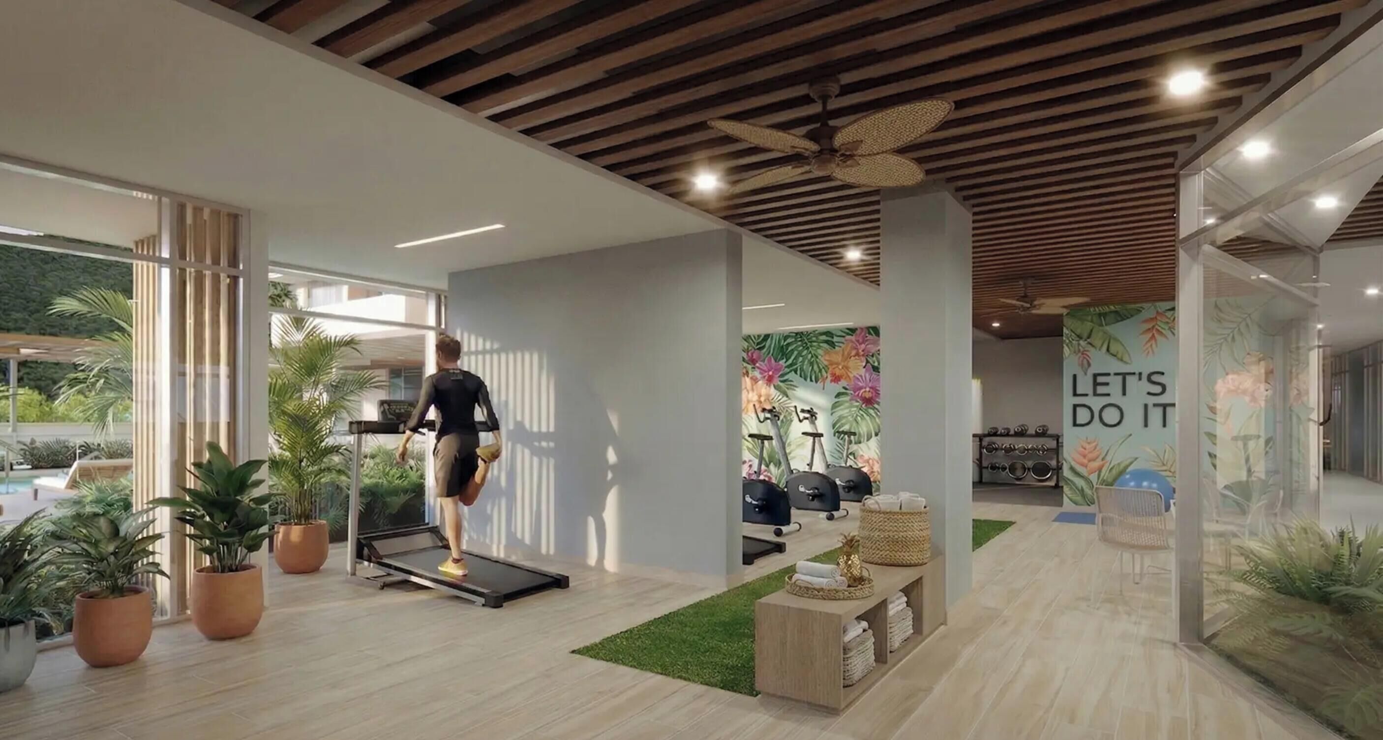 Een moderne sportschool met een loopband, hometrainers en een motiverende muur.