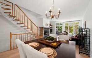 A modern interior with a staircase, dining area, and seating. - L'Après-Ski Mont-Tremblant (Mont-Tremblant)