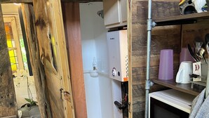A compact kitchen with a microwave, a sink, and a refrigerator. - Cozy treehouse ! Great kids experience !Or adult ! Fire pit ONLY SLEEPS 2 (Lavon)