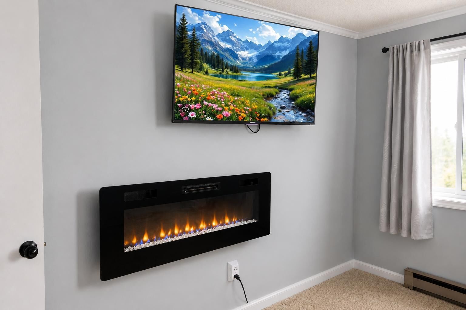 A room with a fireplace and a mounted TV displaying a landscape.