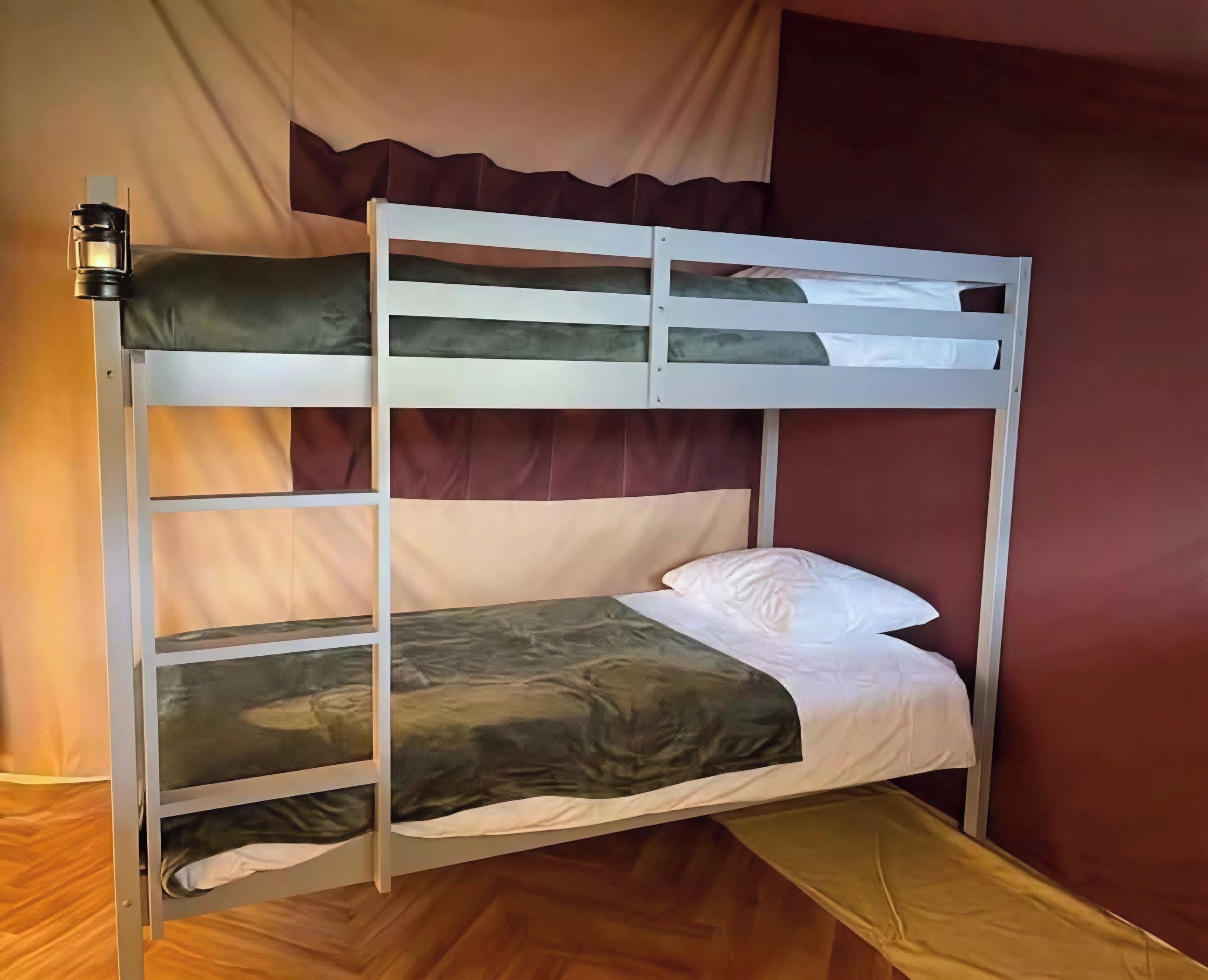 A bunk bed with a mattress, pillows, and a blanket.