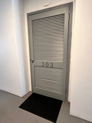 A door with the number 303, a black doormat, and a white wall. - -NEW LISTING-Waterfront Condo 2bd/2bth-Stunning Destin Harbor Views Holiday Isle (Destin)