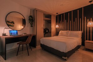 A modern bedroom with a bed, a desk, and a computer. - Private Jacuzzi, Rooftop & BBQ Loft in Medellín (Medellín)