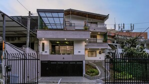 A modern multi-story residential building with a garage, balconies, and solar panels. - Private Jacuzzi, Rooftop & BBQ Loft in Medellín (Medellín)