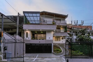 A modern multi-story residential building with a garage, balconies, and solar panels. - Private Jacuzzi, Rooftop & BBQ Loft in Medellín (Medellín)