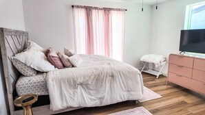 A bedroom with a bed, a dresser, a television, and a window with curtains. -  Resort-Style Oasis Near Old Town Scottsdale (Scottsdale)