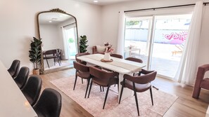 A dining area with a white table, brown chairs, a large mirror, and a view of the outside. -  Resort-Style Oasis Near Old Town Scottsdale (Scottsdale)