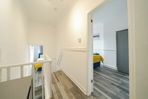 A hallway with a staircase leading to a bedroom. - Sleeps 5, Free Parking, Stylish Spacious Home (Kingston upon Hull)