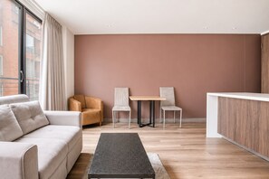 A modern living room with a sofa, two chairs, a coffee table, and a wooden cabinet. - 2-bedroom apartment in lovely Bogotá with fitness room access (Bogotá)