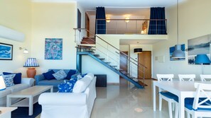A modern living room with a staircase, a dining area, and a kitchen. - The Sea Terrace - Rooftop Beach Duplex - Centre (Portimão)