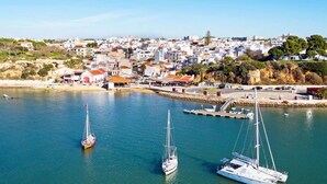 A coastal town with a marina, boats, and buildings. - The Sea Terrace - Rooftop Beach Duplex - Centre (Portimão)