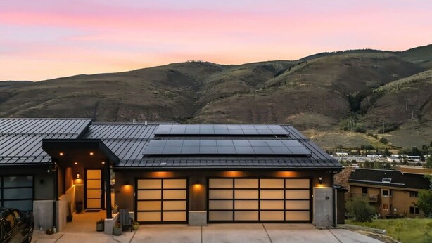 A modern house with a garage, solar panels, and a driveway. - EagleVail Designer Retreat | Sleeps 16 (Vail)