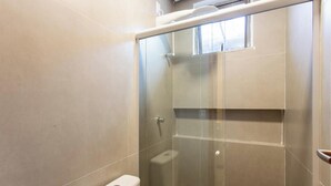 A modern bathroom with a glass-enclosed shower, a toilet, and a towel rack. - House by Lagoon, Near Beach Cdl0007 (Maraú)