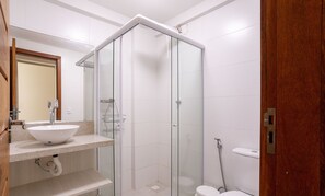 A modern bathroom with a glass shower enclosure, a white sink with a granite countertop, and a toilet. - Comfort in Marau: 200m From the Beach - Cpr0108 (Maraú)