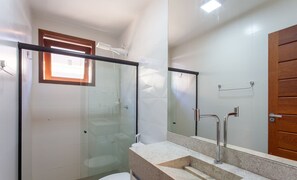 A bathroom with a glass shower enclosure, a wooden door, and a marble sink. - Apart in Condo w/ Barbecue Grill and Pool Cvb0110 (Maraú)