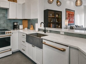 A modern kitchen with white cabinetry, a black sink, and a built-in oven. - Sedona Single-Level · Remodeled, Two Kings, Red Rock Views, Tennis, Pool & Golf (Sedona)
