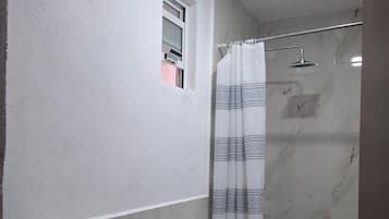 Bathtub, towels, soap, shampoo