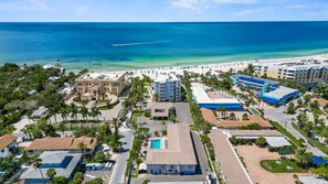 A coastal resort with multiple buildings, a swimming pool, and a beach. - Siesta Sands - Unit 609 (Siesta Key)