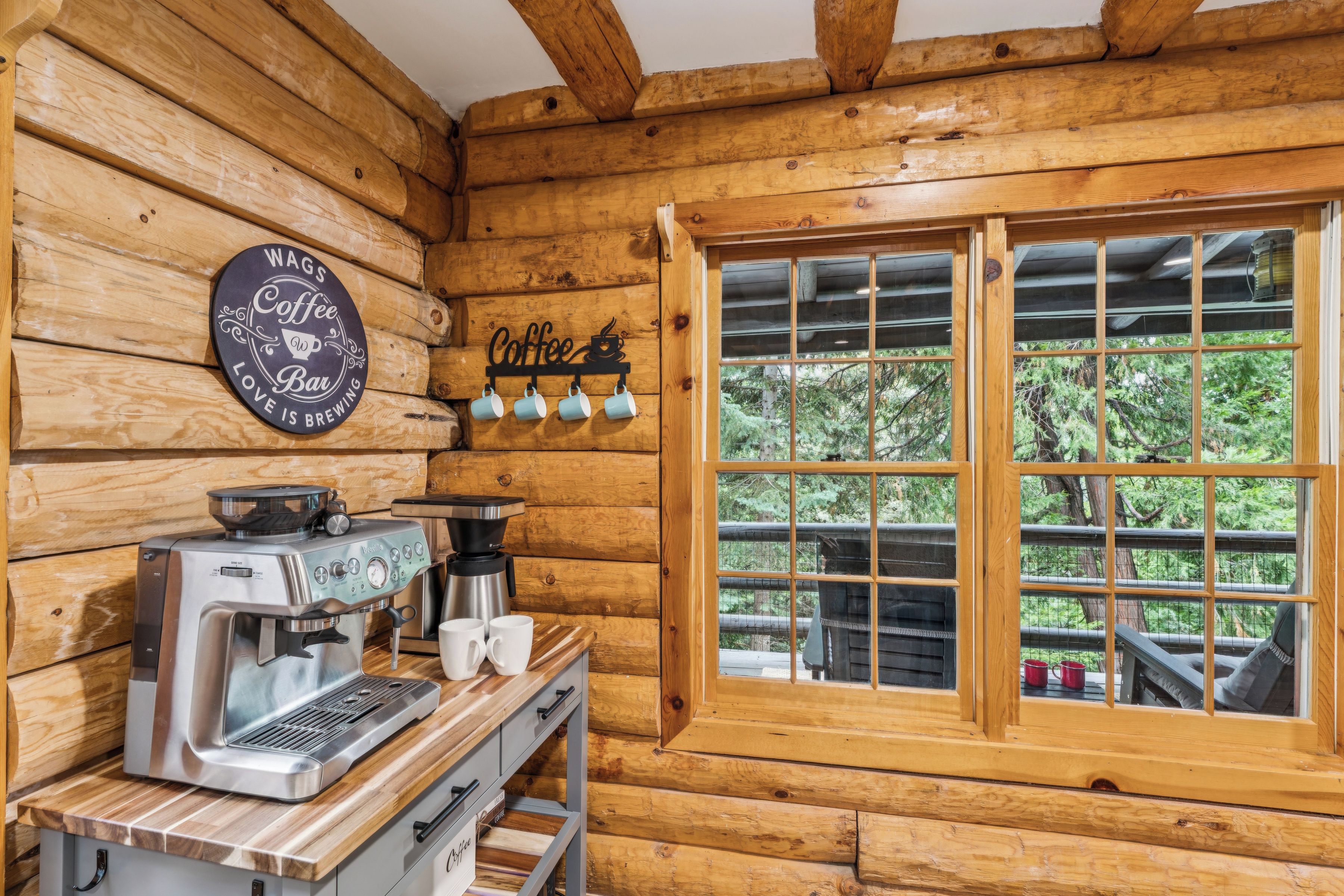 A rustic wooden interior with a coffee station featuring an espresso machine and a coffee grinder.