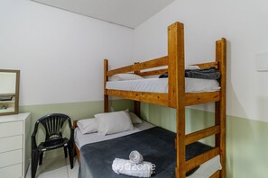 A bunk bed with a wooden frame, a desk with a chair, and a mirror on the wall. - Functional Loft in the Center of Floripa Flt0001 (Florianópolis)