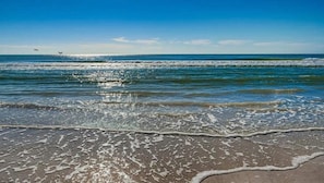 A beach with waves and a clear sky. - SR-40, Lovely Courtside Unit (Siesta Key)
