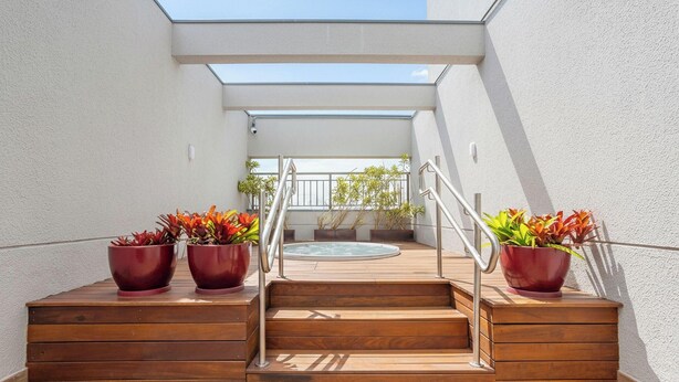 A set of wooden steps leading to a rooftop terrace with a hot tub and potted plants. - Full Apt 250m From Paulista Metro Station Nxo1402 (São Paulo)