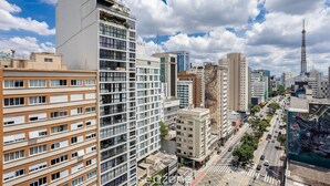A cityscape with high-rise buildings, a busy street, and a prominent tower. - Full Apt 250m From Paulista Metro Station Nxo1402 (São Paulo)