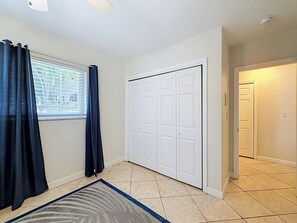 A room with a window, a door, and a tiled floor. - BLUE LAGOON (Lauderdale-by-the-Sea)