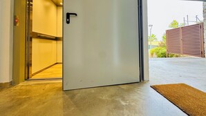 An interior view of a building with a door leading to an outdoor area.