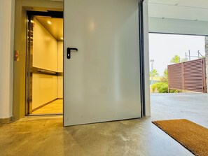An interior view of a building with a door leading to an outdoor area.