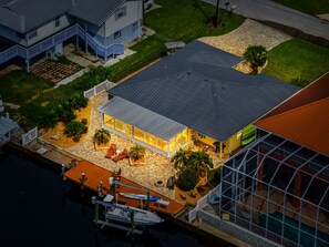 A residential property with a large glass-enclosed patio, a boat dock, and a swimming pool. - Rod and Reel Haven on Minnow Creek (Hernando Beach)