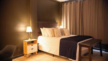 Deluxe Suite | Down comforters, desk, laptop workspace, blackout drapes