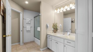 A bathroom with a large mirror, a shower, and a vanity with a sink. - River Ridge 420B -Westside Studio, Pool & Hot Tub (Bend)