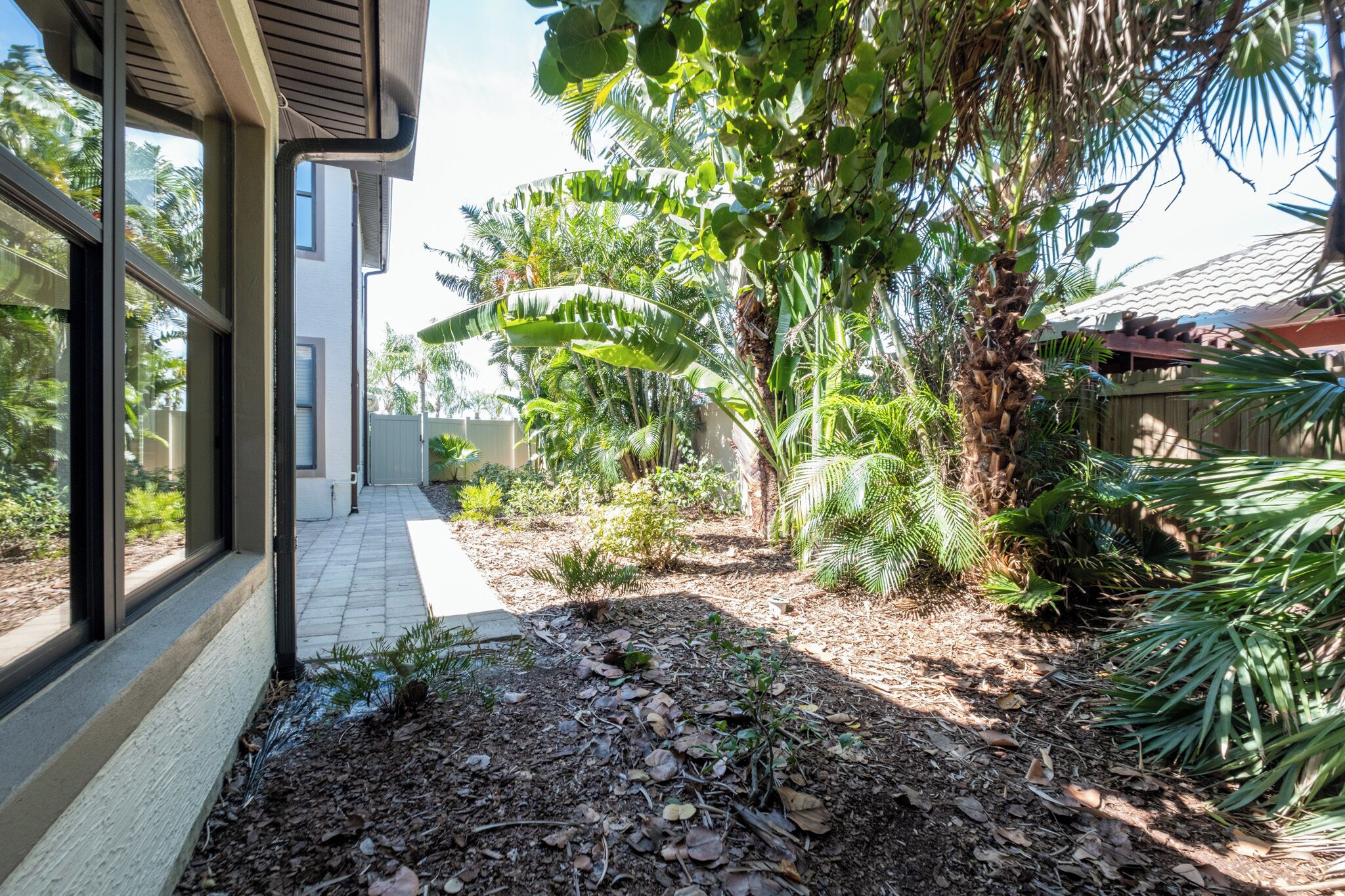 A pathway leading to a house with a garden.