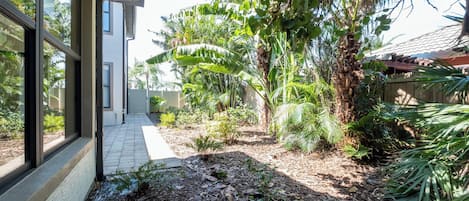 A pathway leading to a house with a garden.