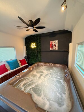 A hot tub with a ceiling fan, a neon sign, and a framed poster on the wall. - 5-Bedroom Luxury Home | Jacuzzi/Sauna/BBQ | 15 Min from the Strip (Las Vegas)
