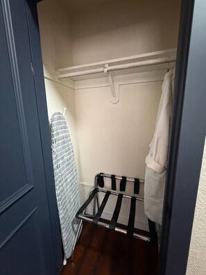 A small, narrow walk-in closet with a metal drying rack and a white towel hanging on the door. - 5-Bedroom Luxury Home | Jacuzzi/Sauna/BBQ | 15 Min from the Strip (Las Vegas)