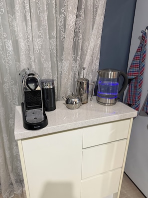 A kitchenette with a Breville coffee maker, a kettle, a pot, and a water jug on a countertop. - Rivervilla tranquillity by the bay
2 bed unit surrounded by native reserves (Griffin)