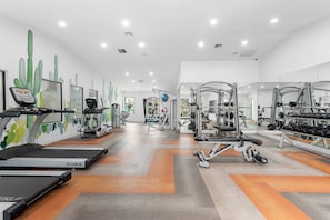A gym with treadmills, elliptical machines, and weightlifting equipment. - Stylish 2BR Getaway Near ASU Pool, Gym + Parking (Tempe)