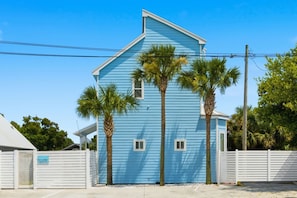 A two-story building with a blue exterior, white trim, and a white fence in front. - Walk to the Beach | 5 Minutes to St. Andrews State Park | Easy Access | Updated (Panama City)