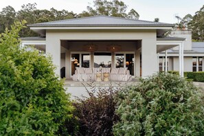 A covered outdoor seating area with a pool table, cushioned chairs, and ambient lighting. - 'Wychwood'- English Garden Estate with Pool (Upper Kangaroo River)
