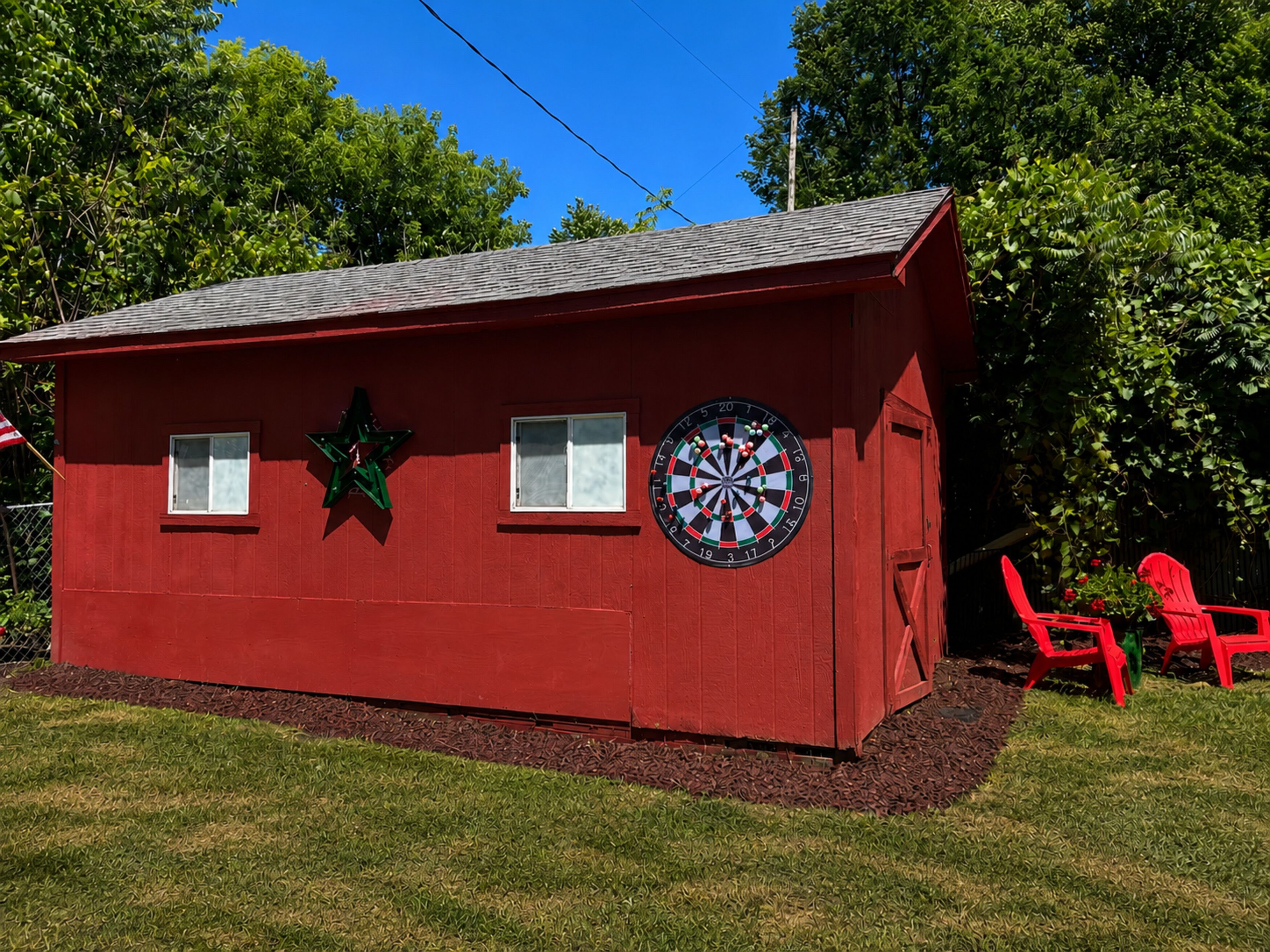 A red building with a dartboard and a star decoration.