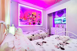 A bedroom with two beds, a TV, and a wall with a colorful mural. - Paradise Palms Family Oasis (Kissimmee)